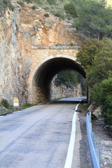 Fototapeta na wymiar Stone tunnel at mountain road
