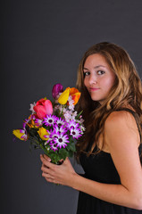 Springtime: Young beautiful woman with black dress an flowers