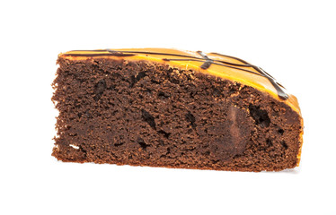 Piece of chocolate cake with icing on white isolated background