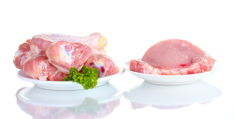 Raw Chicken Drumsticks and pork steak isolated on white