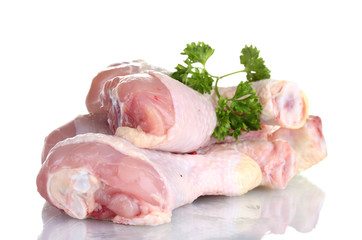 Raw Chicken Drumsticks in plate with parsley isolated on white