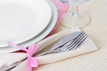 Table setting with fork, knife, plates, and napkin