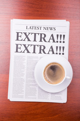 The newspaper EXTRA! EXTRA!  and coffee