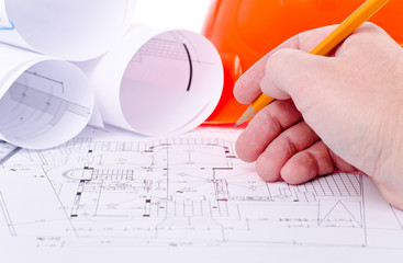 hand with pencil  on drawings