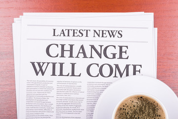 The newspaper  CHANGE WILL COME  and coffee
