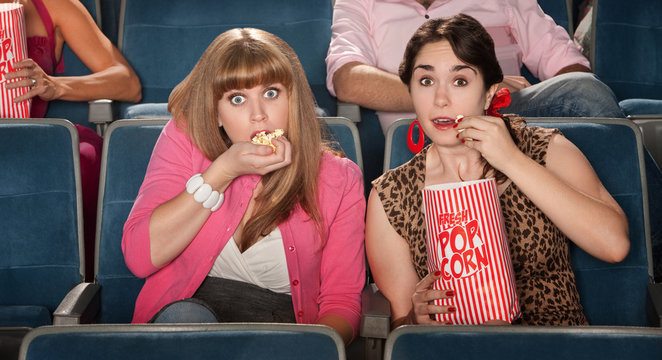Amazed Women Eating Popcorn