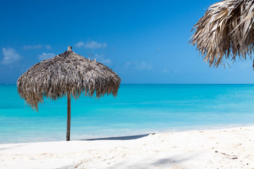 Fototapeta na wymiar Beach Umbrella on a perfect white beach in front of Sea