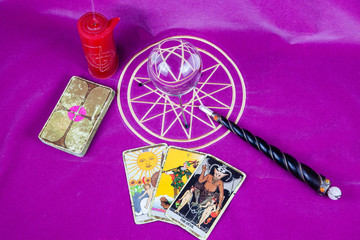 Tarot cards with the crystal ball, candle and magic wand.