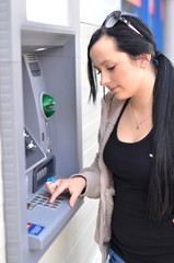 Beautiful woman using ATM