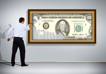 Fototapeta premium Businessman with a paint brush and banknote