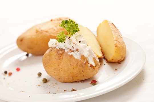 Baked potato filled with soft cheese