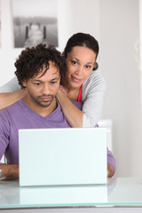 Couple at home with a laptop computer