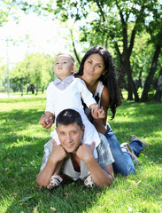 Naklejka na ściany i meble Family together in the summer park
