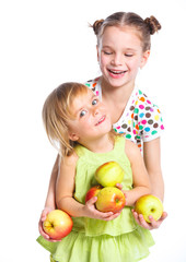 Fototapeta premium Portrait of two happy girls with apple