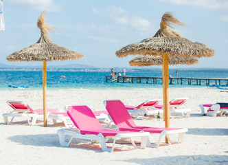 Two chairs and umbrella on the beach.