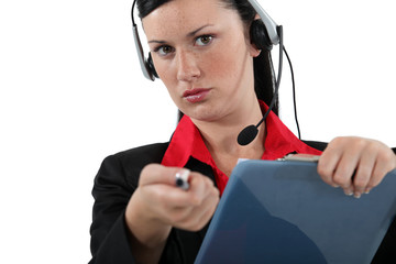 Woman with a headset and clipboard