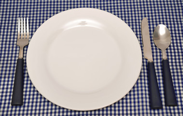 Tableware on blue napkin