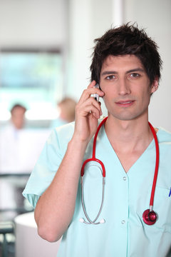 portrait of a male nurse on the phone