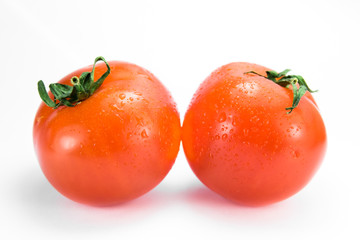 two red ripe tomatoes side by side