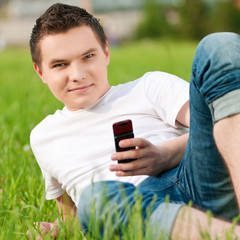 Man on grass with phone