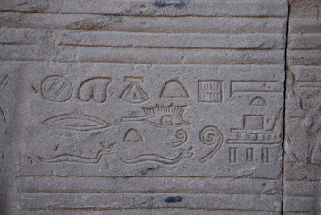 Egyptian hieroglyphs engraved on stone in Horus temple, Egypt