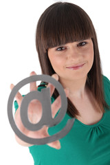 Teenager holding the at symbol