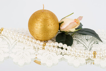 The beautiful bridal rose and golden candle with beads