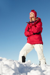 Woman Standing In Snow Wearing Warm Clothes On Ski Holiday In Mo