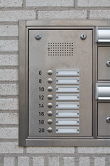 close-up of a modern nameplate with intercom doorbell
