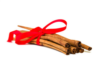 Composition of spices with cinnamon sticks isolated on white