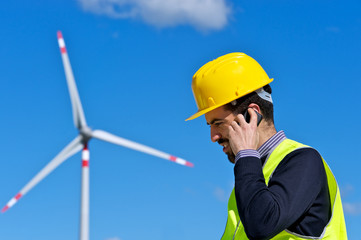 Engineer in Wind Turbine Power Generator talk at phone Station