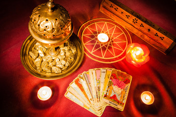 Tarot cards illuminated by candlelight. - obrazy, fototapety, plakaty