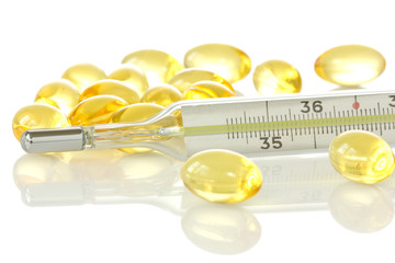 medical thermometer and yellow pills