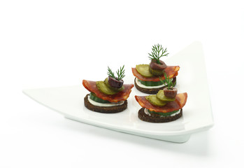 Canape with salami and vegetables