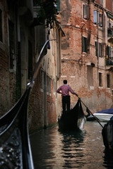 Fototapeta na wymiar Gondolier on grand canal, Venice, Italy