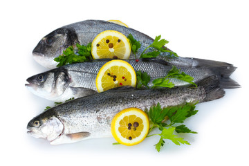 Fresh fishes with lemon, parsley and spice isolated on white