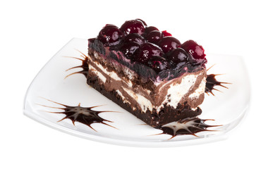 Chocolate cake with cherry on top on a white background