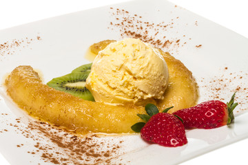 Dessert of banana, ice-cream, caramel, strawberry and mint