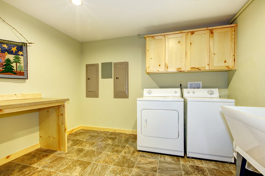Laundry roon with sink and folding desk.
