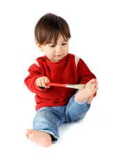Child playing with a brush