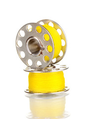 Metal spools of thread isolated on white