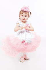 Portrait of a young girl in beautiful pink dress