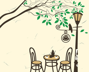 Open-air cafe under a tree with a lantern