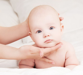 Mother massaging baby