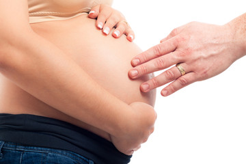 Pregnant woman and male hand touch