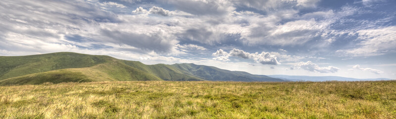 Fototapeta premium Summer landscape. Clouds and mountains