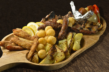 Rustic tray with various meats and cheese balls - isolated