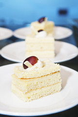 Row of small sponge-cakes on plates