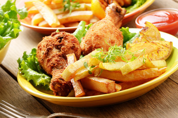 Fried drumsticks with french fries