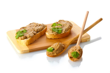 Fresh pate on bread on wooden board isolated on white